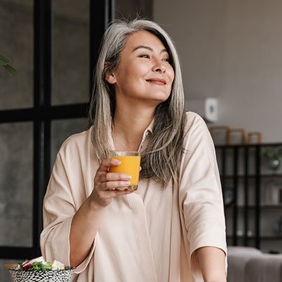 woman reading book and drinking juice 56WEDAX.jpg